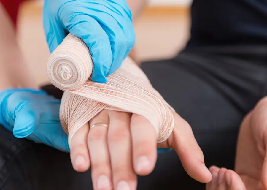 First Aid training — bandaging a hand
